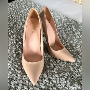 Nude patent leather pumps. Never been worn. Very cute and sassy!
